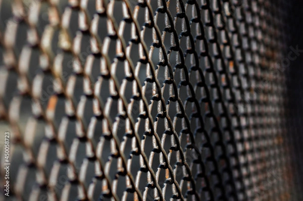 Obraz selective focus of dark metal mesh fence