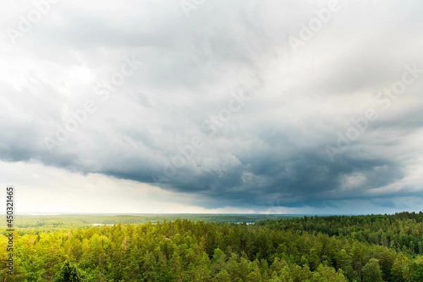 Fototapeta Storm with dark rain clouds over the Swedish forest and lakes at the Aboda Klint viewpoint in Högsby