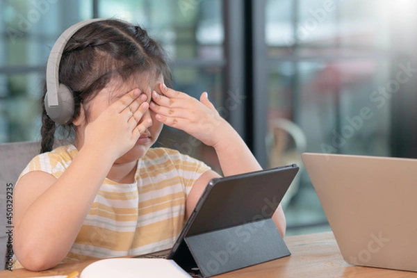 Obraz Asian girl covered her eyes from digital eye strain, girl used tablets too much to cause eye strain,eyes problems from using a tablet,education and vision problems.