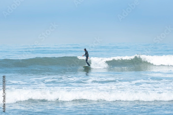 Obraz surfer in action surfing the wave