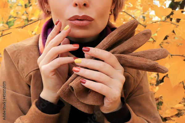 Obraz A model with accessories and a multi-colored manicure in autumn.