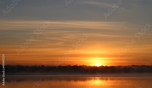 Obraz Sun Peeking Over Trees with Orange Clouds
