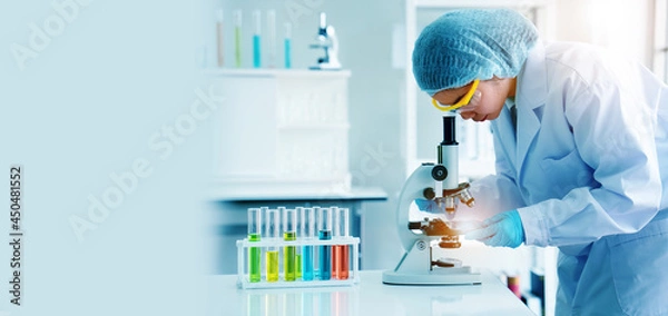Fototapeta Scientist or doctor use microscope to test for the coronavirus (COVID 19). Or a new flu virus to save people life In the lab Or hospital. Success in research the treatment of patient