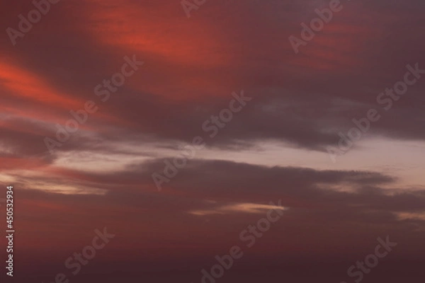 Obraz Sunrise sky with red color fire on a cloudy winter day. Space for text.