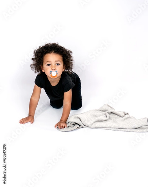 Obraz Beautiful mixed race 2 years and half old boy sucking a nipple while crawling