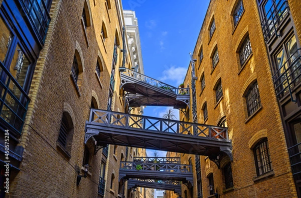 Fototapeta Shad Thames in London, UK. Historic Shad Thames is an old cobbled street known for it's restored overhead bridges and walkways. This old street is in Bermondsey near Tower Bridge and London Bridge.