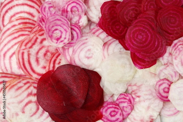 Fototapeta Various varieties of beets cut into thin slices. Chioggia beetroot, ordinary beetroot 

