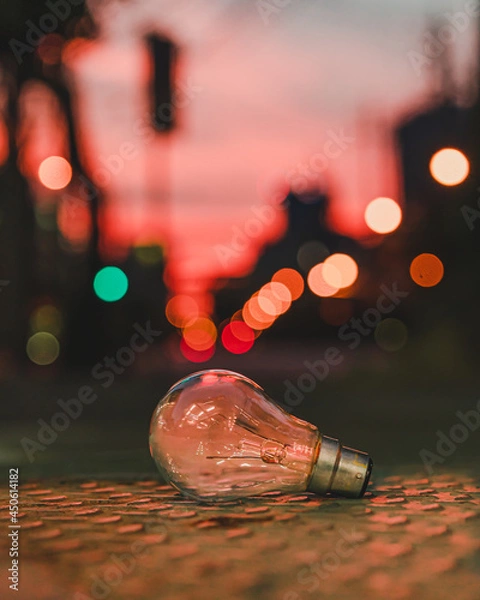 Fototapeta Old Light bulb on the street beautiful bokeh background which show idea concept with innovation and inspiration.