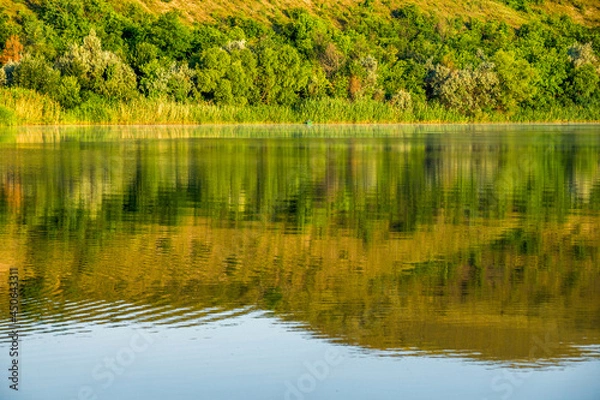 Obraz Reflection of a high bank in the water