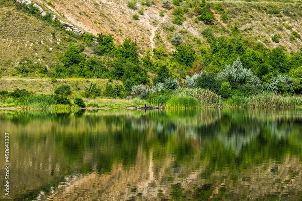 Obraz Reflection of a steep bank in the water