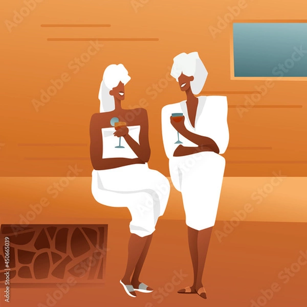 Fototapeta Adult ladies in a bathhouse in white coats with towels and drinks in glasses are sitting on a tree and talking. Girls gossip in the sauna, the concept of relaxing with friends.