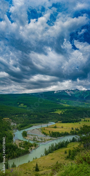 Fototapeta picturesque view of plain with lake near hills and mountains under white fluffy clouds in blue sky at sunny day