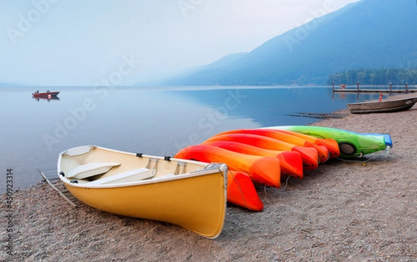 Obraz Overview of Lake McDonald after sunset with kayaks in foreground. Lake McDonald is the largest lake in Glacier National Park in Flathead County in the U.S. state of Montana