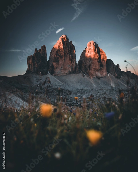 Fototapeta Three peaks of Lavaredo (Drei Zinnen or Tre Cime di Lavaredo) in the Sexten Dolomites National Park during sunrise with light on the peaks