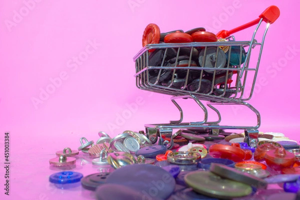 Obraz A supermarket trolley with various buttons in it. 