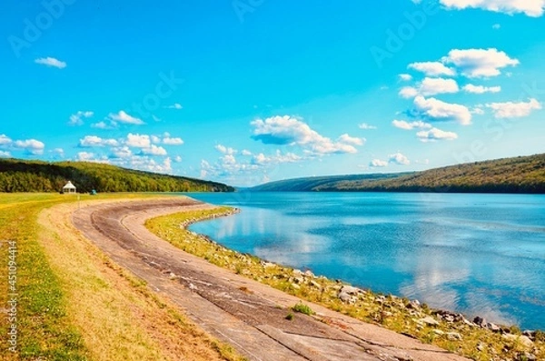 Fototapeta Scenic view of Hemlock Lake, one of the minor Finger Lakes. It is mostly located in Livingston County, New York, south of Rochester. It’s forever-wild, tranquil landscape the perfect place to unwind. 