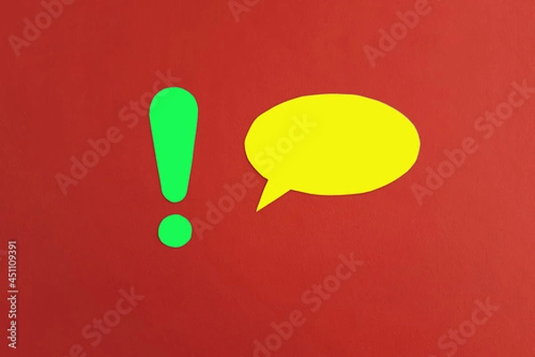 Fototapeta The exclamation mark is green, the oval for the text is yellow on a red background. Drawing attention, communicating information.