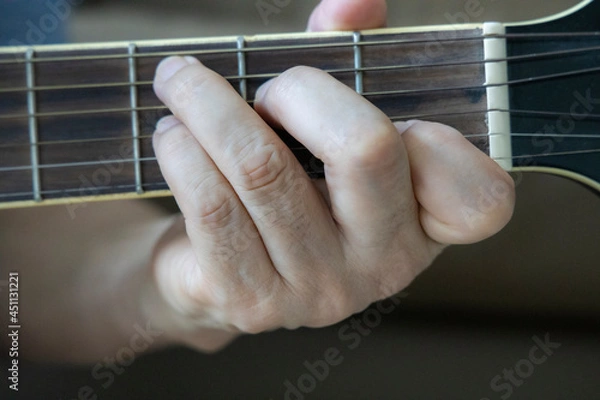 Obraz hand holding guitar chord for playing