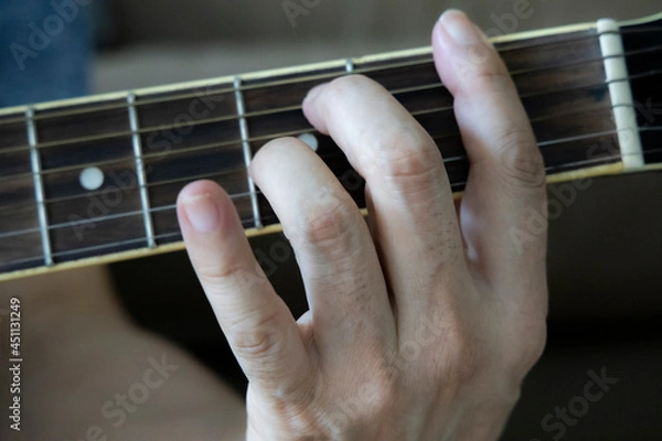 Obraz hand holding guitar chord for playing