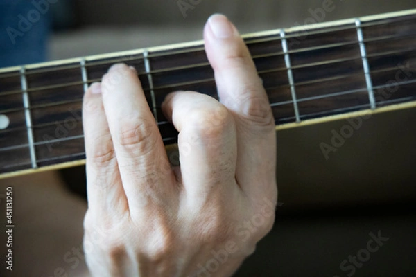 Obraz hand holding guitar chord for playing
