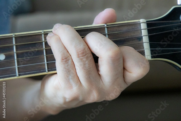 Obraz hand holding guitar chord for playing