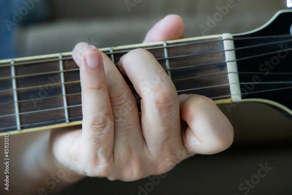 Obraz hand holding guitar chord for playing
