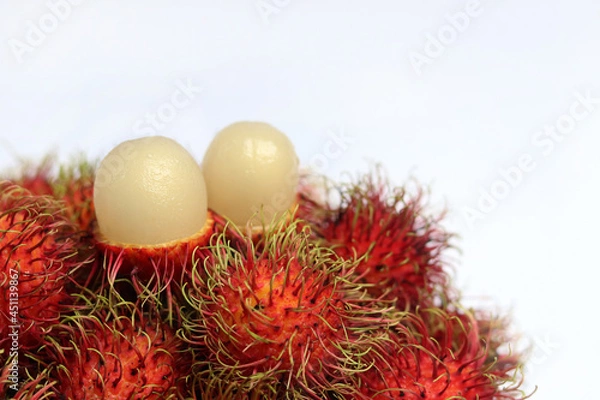 Fototapeta Rambutan on white background. A Sweet delicious fruit with health benefits ranging from weight loss and better digestion to increased resistance to infections.
