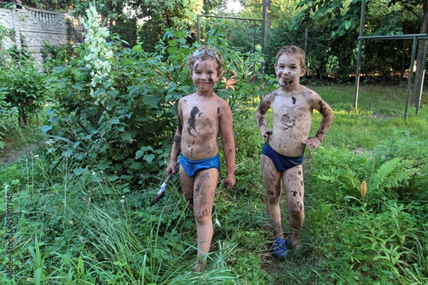 Fototapeta Two boys posing soiled in mud