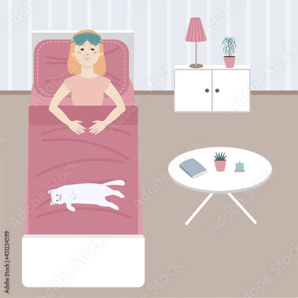 Fototapeta In the morning the girl woke up and lies in bed next to the cat.