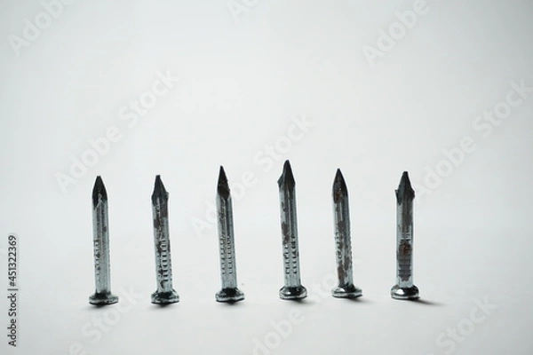Fototapeta untidy rows of nails on a white background