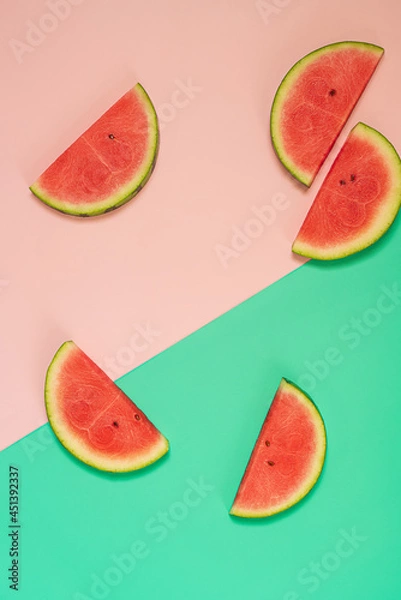 Fototapeta  Slices of fresh watermelon on pink and green background.Flat lay with copy space.Trendy food photography.