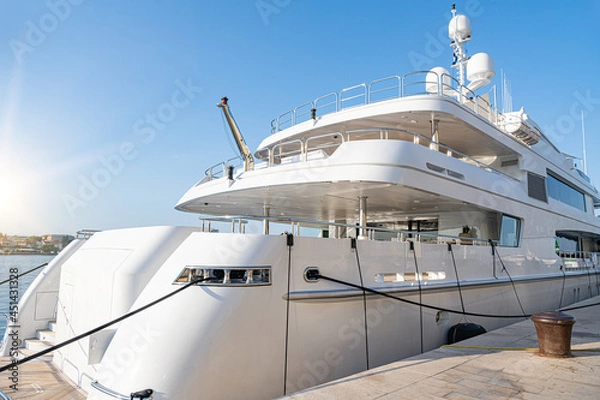 Fototapeta Large catamaran at the marina. Pleasure or passenger catamaran on the pier.
