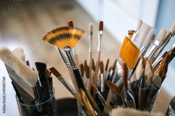 Fototapeta Group of fresh new paintbrushes. Assorted unused art supplies. Various different sizes and colors.