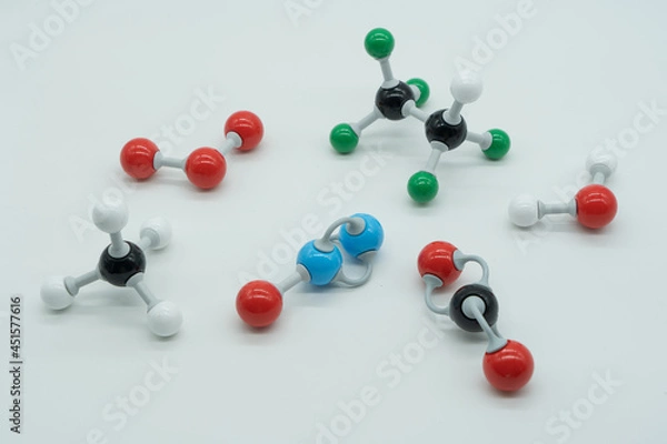 Fototapeta Picture of different greenhouse gases made by molecular model on white background. Chemical formula of nitrogen monoxide, carbon dioxide, methane, water, ozone and HFC - 125.