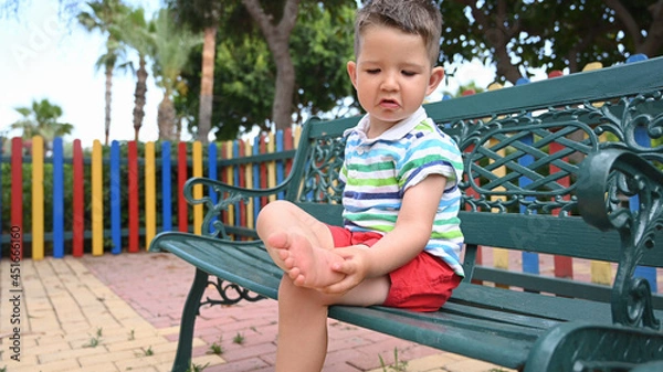 Fototapeta A child injured his foot while playing in the playground