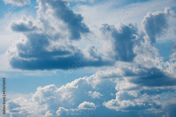 Obraz Blue sky background with fluffy white clouds. Vivid view of natural scene at sunny day