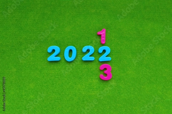 Obraz The figures are 2022, with the transition to 2023 on a green background. The new year is coming.