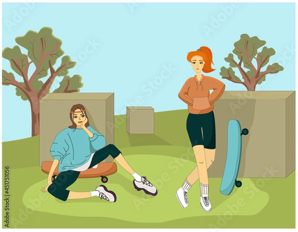 Obraz Two girls in the park in sweatshirts in a sporty style on skateboards are resting.