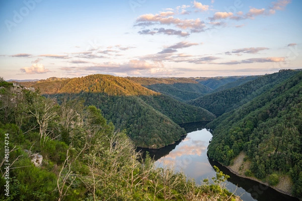 Fototapeta Start of golden hour on the landscape with reflection in water, end of July 2021