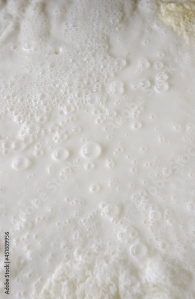 Fototapeta Fresh milk. Bubbles forming scene background.