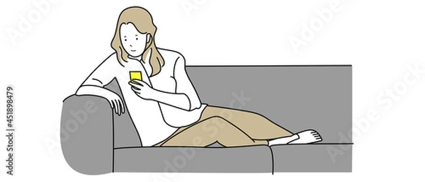 Obraz ソファでスマホ操作する女性