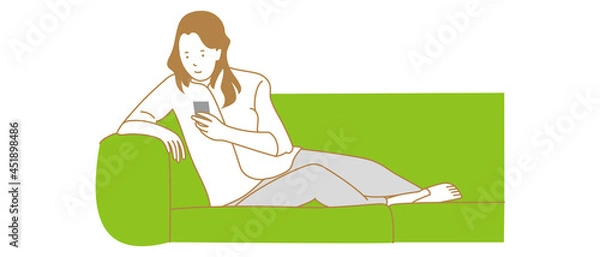 Obraz ソファでスマホ操作する女性