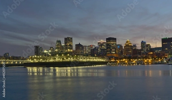Fototapeta Montreal Downtown skyline during the twilight blue hour. Foreground is Saint Lawrence (Laurent) river.