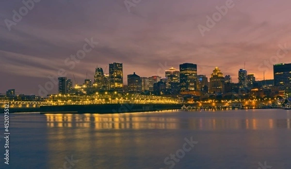 Fototapeta Montreal Downtown skyline during the sunset. Foreground is Saint Lawrence (Laurent) river.