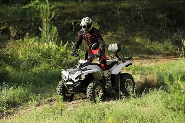 Fototapeta Man driving modern quad bike on sandy road. Extreme sport