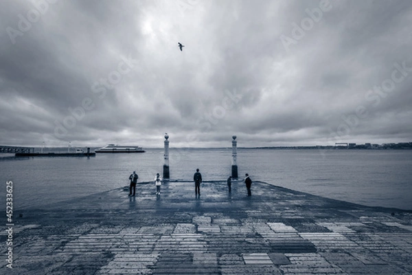 Fototapeta Bad weather in Lisbon. River Tagus. Old town embankment near Commerce Square. Portugal