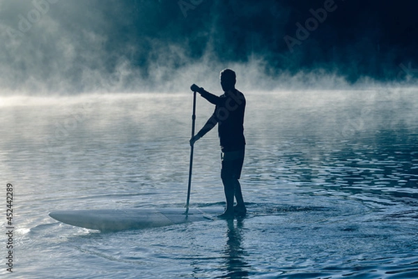 Fototapeta Man balancing on sup board