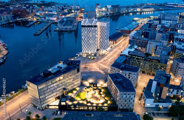 Fototapeta Aerial view of the Jatkasaari neighborhood is a brand new district in Helsinki. The modern buildings of hotels, offices, and residential buildings. The night cityscape.