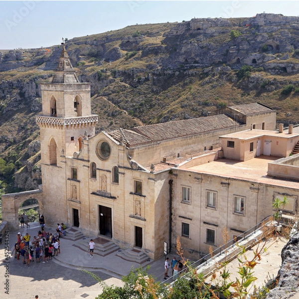 Fototapeta Matera, Italy - August 17, 2020: View of the Sassi di Matera a historic district in the city of Matera, well-known for their ancient cave dwellings. Basilicata. Italy