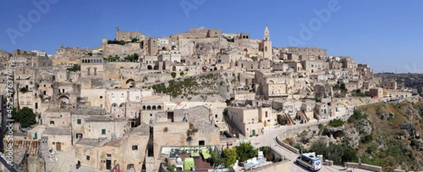 Fototapeta Matera, Italy - August 17, 2020: View of the Sassi di Matera a historic district in the city of Matera, well-known for their ancient cave dwellings. Basilicata. Italy